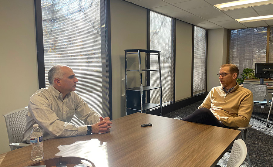 Crystal Farms president Tim Bratland speaks to Dairy Foods Editor Brian Berk (left).