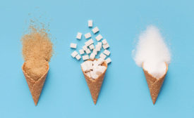 ice cream cones filled with brown sugar, white sugar and cubed sugar